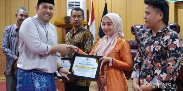 Bupati Merangin H. M. Syukur bersama Ketua TP PKK Lavita Syukur menyerahkan piagam penghargaan kepada tiga staf penyelamat Bilqis pada Rakor DRPPA di Aula Bappeda Merangin, Kamis (20 November 2025). (Dok: Diskominfo Merangin)