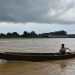 Warga menggunakan perahu untuk melintasi kawasan pesisir Tanjab Timur di tengah peringatan potensi cuaca ekstrem, Senin (1/12/2025). (Dok: Rudi)