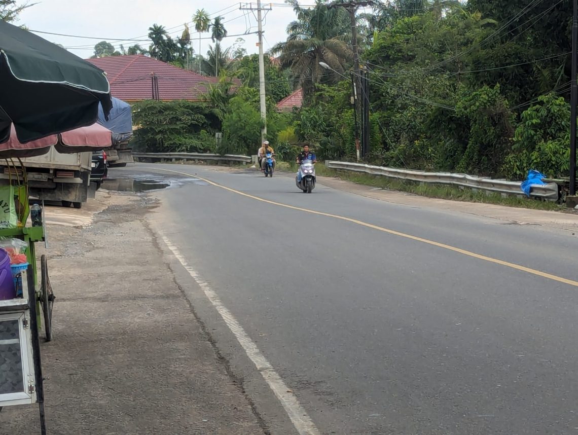 Arus lalu lintas di Jalur Lintas Timur Sumatera, Kecamatan Merlung, Kabupaten Tanjungjabung Barat, kembali lancar setelah banjir surut, dengan pengaturan lalu lintas oleh personel kepolisian di lapangan. (Dok: Alpin)