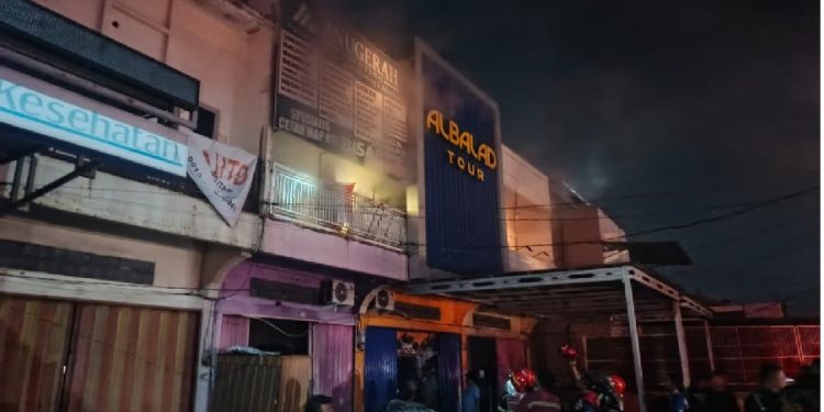Petugas Damkar Kota Jambi berjibaku memadamkan kebakaran ruko percetakan di Jalan Patimura, Kenali Besar, Jumat malam. (Dok: Alpin)
