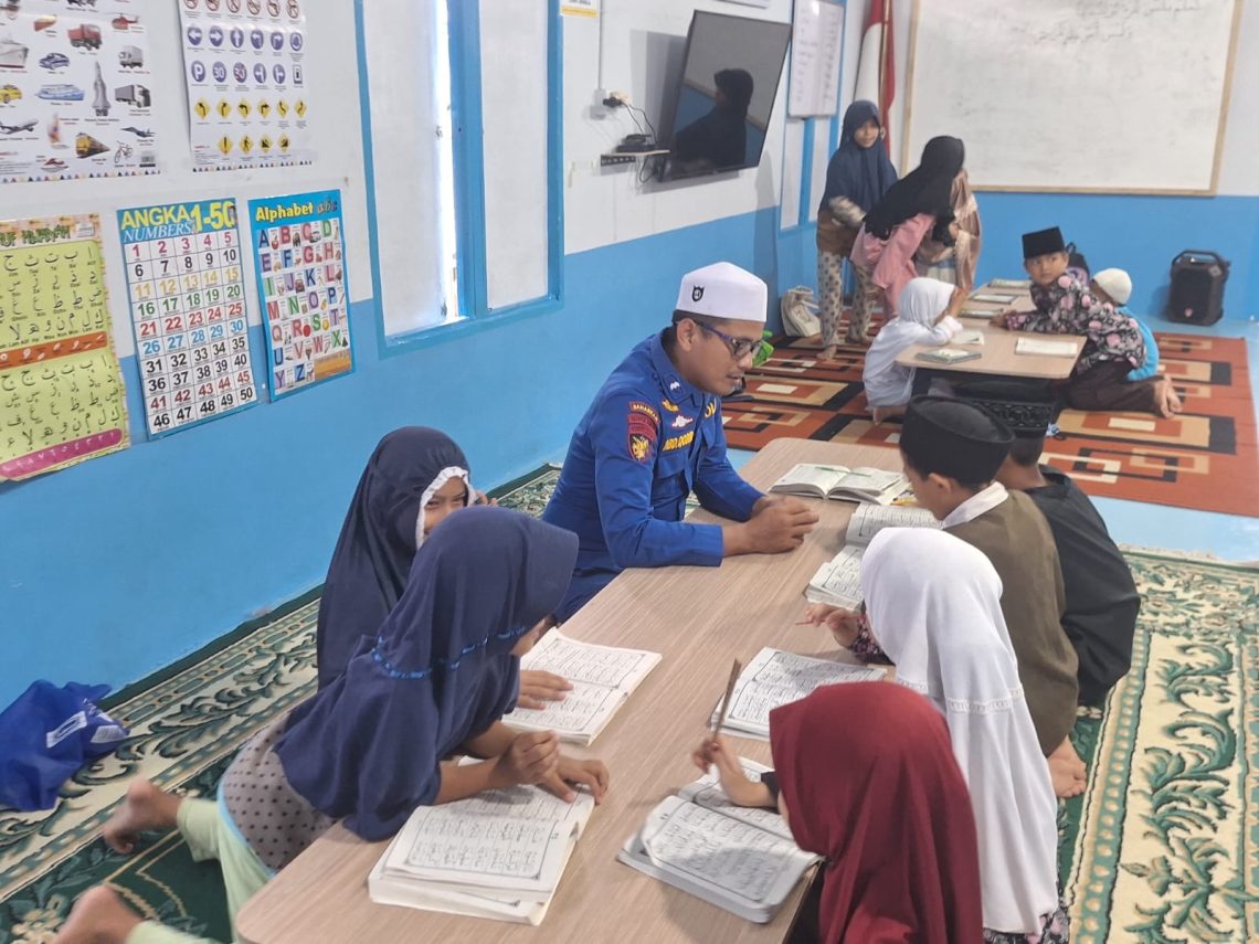 Personel Ditpolairud Polda Jambi bersama anak-anak mengikuti kegiatan mengaji di Rumah Baca Bhayangkara Bahari di Telanaipura, Kota Jambi, Jumat (1/5/2026). (DOk: Alpin)